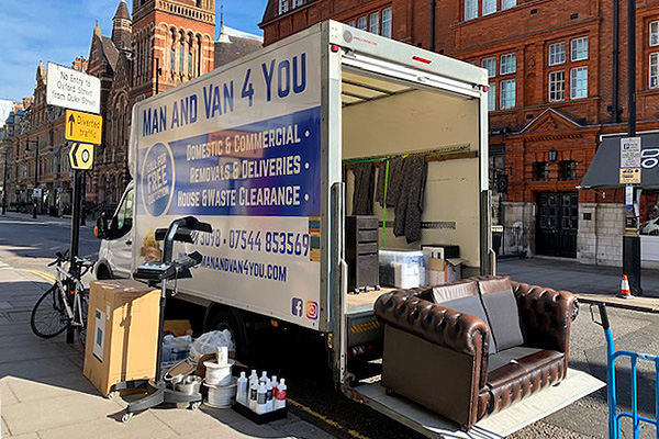 Loading furniture and other household items into the van.